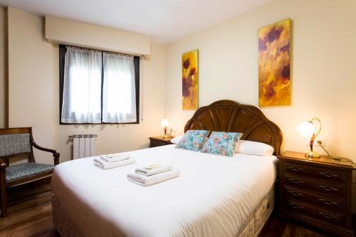 a bedroom with a bed with towels on it at Bordari by Smiling Rentals in Hondarribia