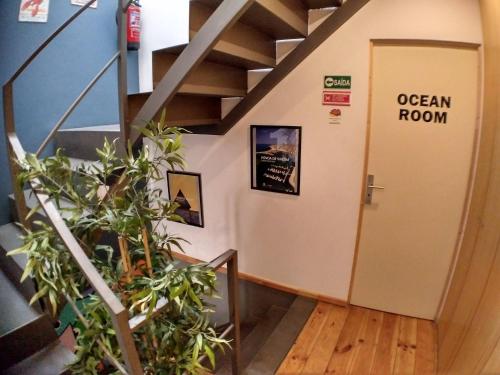 an open door in a room with a stair case at Sardines and Friends Hostel 04 in Póvoa de Varzim