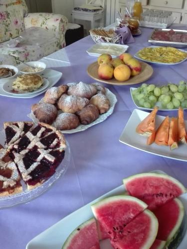 a table topped with plates of food and fruit at B&B Il Belvedere in Guardialfiera