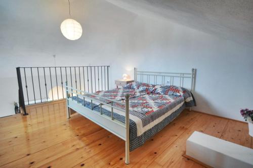 a bedroom with a bed and a wooden floor at Villa Carmen in Sali