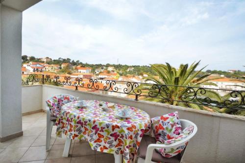 a table and chairs on a balcony with a view at Villa Carmen in Sali