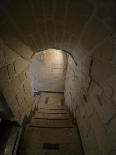a tunnel with a staircase in a brick wall at B&B Favignana in Favignana