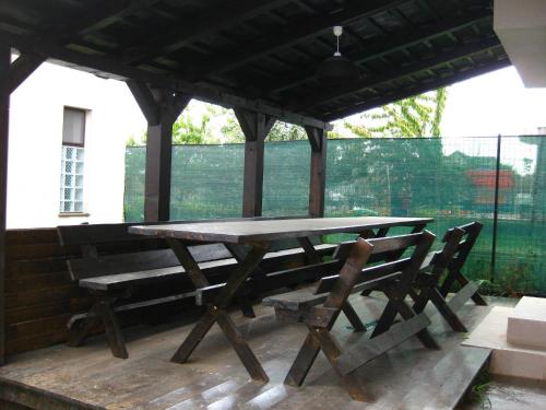 a picnic table and chairs on a patio at Vila Azul in Eforie Nord