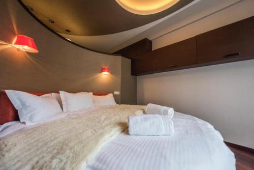 a bedroom with a large bed with white pillows at Parliament on Rustaveli Studio in Tbilisi City