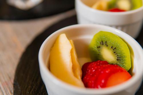 a white bowl filled with fruit on a table at Alla Riva in Verona
