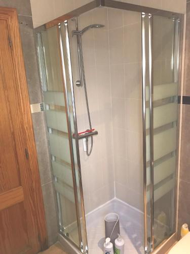 a shower with a glass door in a bathroom at Aina in Cala Pi