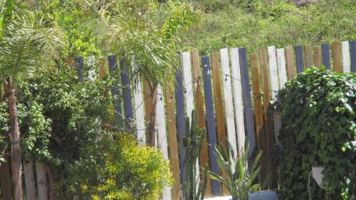 a wooden fence with trees in front of it at Hôtel La Villa Patricia - Charme et Tradition in Villefranche-sur-Mer