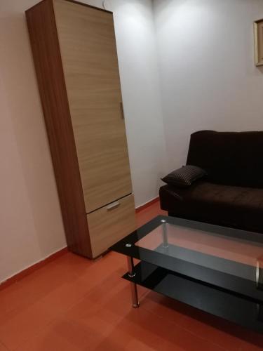 a living room with a couch and a glass table at Rooms and Apartments Milana in Bar
