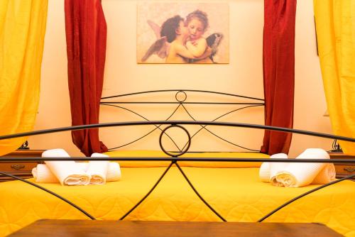 a close up of a bed with yellow sheets at B&B Favignana in Favignana