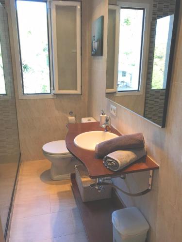 a bathroom with a sink and a toilet at Casa Xisca in Cala Pi