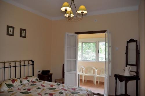 a bedroom with a bed and a table and chairs at Casa en plena naturaleza. in Valdecañas de Tajo