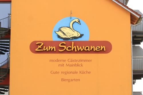 a sign with a swan on the side of a building at Gasthof Zum Schwanen in Kleinostheim