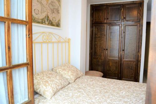 a bedroom with a bed with a pillow on it at Casa Plaza Sierra Grazalema in Grazalema