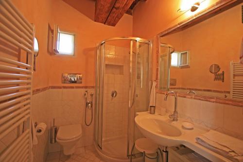 a bathroom with a sink and a shower and a toilet at Casa Marsilva - holiday apartment in old town centre, near the lake in Toscolano Maderno