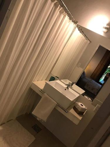 a bathroom with a sink and a mirror at LA USINA VIEJA in Esquina