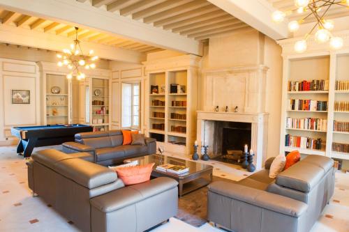 a large living room with couches and a fireplace at Moulin de Vaucroze in Sorgues