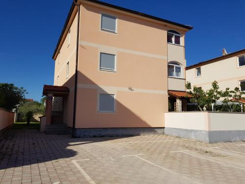 a large building with a driveway in front of it at Apartment Onbria Mar in Medulin