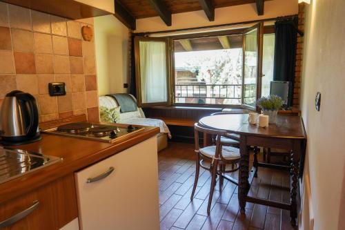 a kitchen with a table and a dining room at Agriturismo La Garzonera in Vergiate