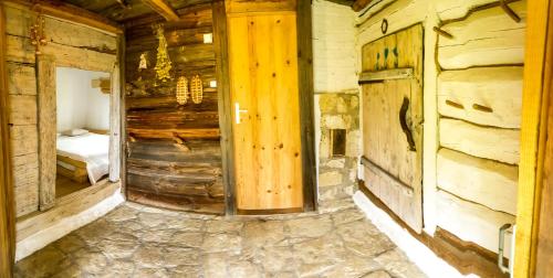 an empty room with a bed in a log cabin at Dzikie Roztocze - Stara Chata in Krasnobród