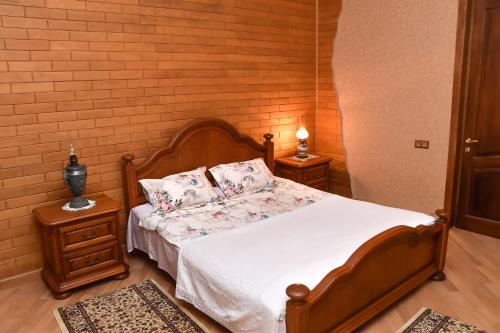 a bedroom with a bed with white sheets and pillows at Sofia in Kutaisi