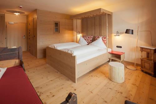 a bedroom with a large white bed in a room at Hotel Oberstdorf in Oberstdorf
