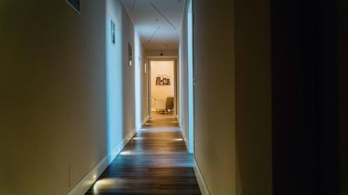 a hallway with a long corridor with lights on the floor at Villa Cua in Ercolano