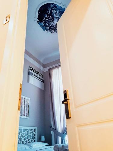 a door to a room with a bed and a ceiling at Villa Cua in Ercolano