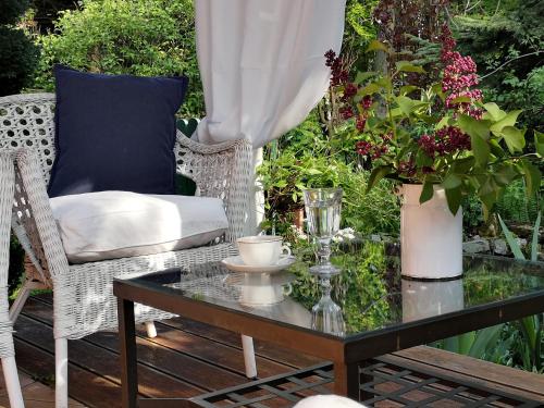 a glass coffee table and a chair on a patio at Ranczo w Dolinie Karpia - blisko "Energylandii" Zator in Spytkowice
