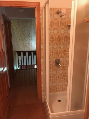 a shower with a glass door in a room at Chalet dell'Orso in Pescasseroli