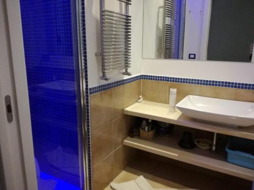 a bathroom with a sink and a shower at Villetta Baia San Montano in Ischia