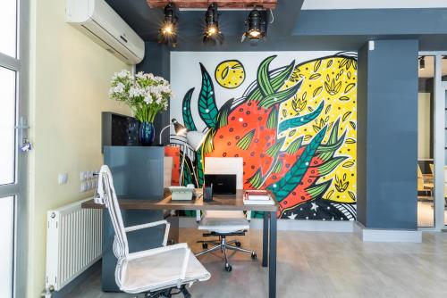 an office with a large mural on the wall at Boutique Hotel MOJO in Tbilisi City