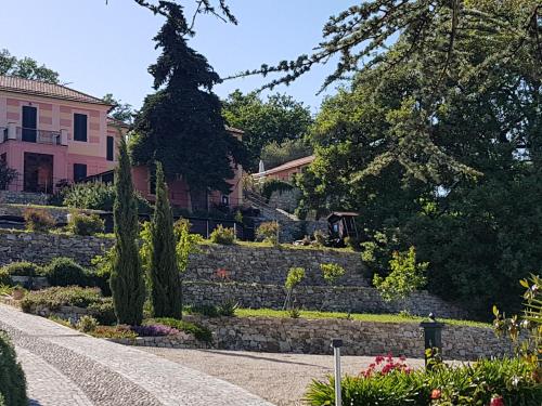 a garden in front of a pink house at Villa Caterina in Imperia