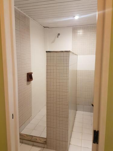 a shower with a glass door in a bathroom at Origen Hotel -Motel- in Buenos Aires