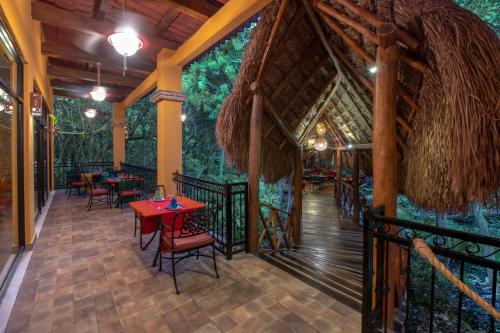 a restaurant with tables and chairs on a deck at Viva Maya by Wyndham, A Trademark All Inclusive Resort in Playa del Carmen