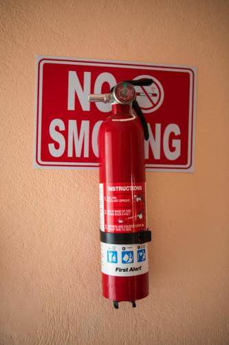 a fire extinguisher is attached to a no smoking sign at LAKE VIEW CONDO in Belize City