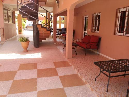 a lobby with a checkered floor and a red chair at Africa 6 Plage in Somone