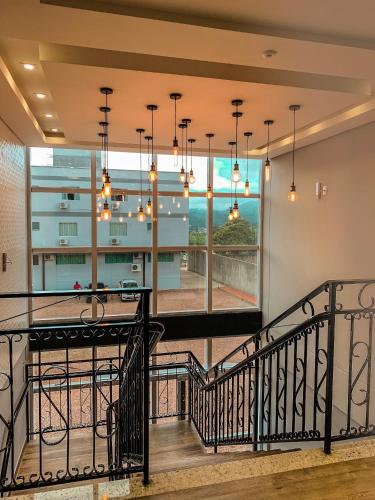 a staircase in a house with a large window at Hotel Bergozza in Rio do Sul