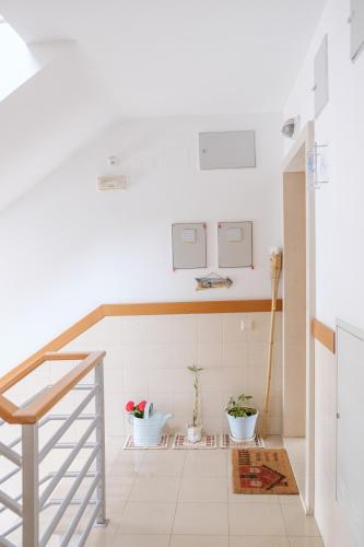 a white kitchen with a staircase and plants at Rito´s Paradise in Nazaré