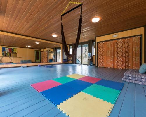 a dance floor with colorful mats on the floor at Honu Hale in Volcano