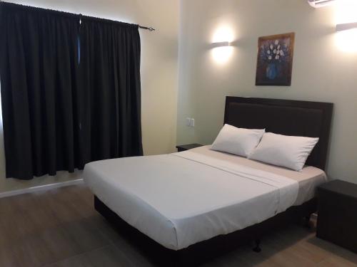 a bedroom with a bed with white sheets and a window at Le Uaina Beach Resort in Falepuna