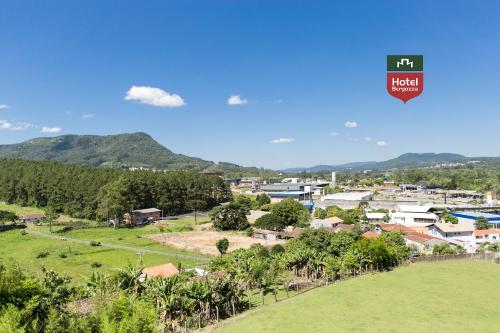 an aerial view of a town with mountains in the background at Hotel Bergozza in Rio do Sul