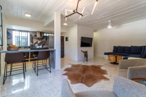 a living room with a couch and a dog in a room at Cuale in Puerto Vallarta