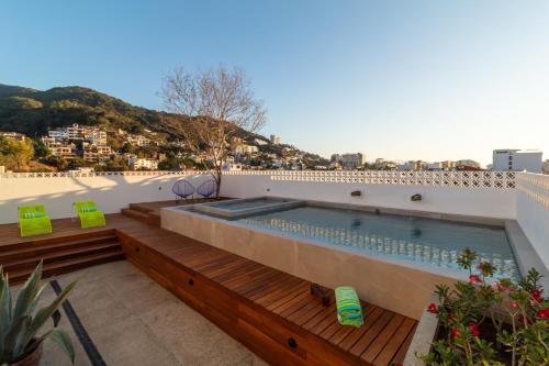 a swimming pool on the roof of a building at Cuale in Puerto Vallarta