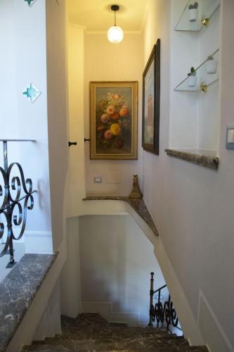 a staircase in a house with a painting on the wall at Villa Laura in Savoca 