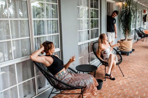 a group of people sitting in chairs looking out of windows at Motel Nomad in Cairns
