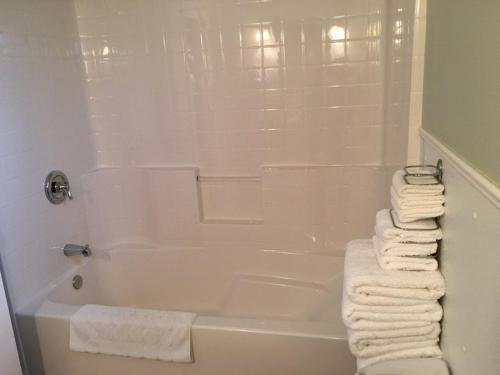 a bathroom with a white tub and white towels at The Cabins at Beaver Creek in Beaver