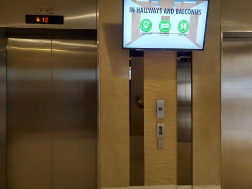 an elevator with a sign in hawkins and bronchoes at Shell Residence Manila in Manila