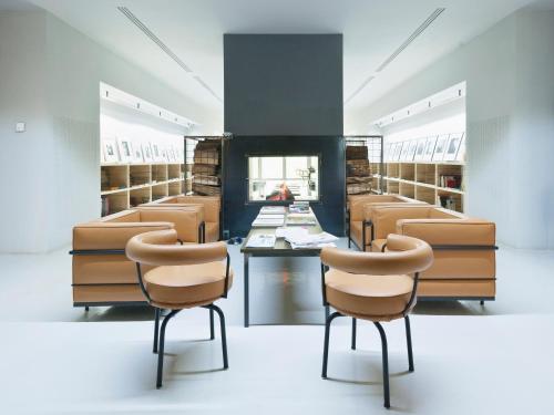 a room with chairs and a table in a library at Antonello Colonna Resort & Spa in Labico
