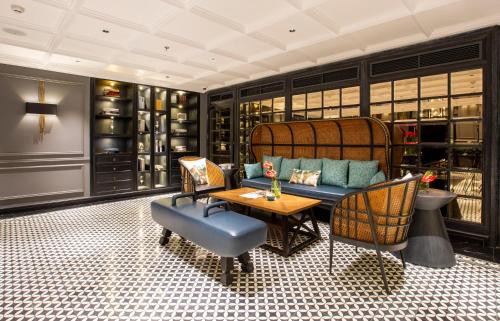 a living room with a couch and chairs and a table at La Siesta Premium Hang Be in Hanoi
