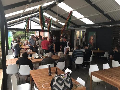 a group of people sitting at tables in a restaurant at Second Valley Caravan Park in Second Valley